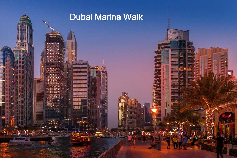An evening scene of Dubai Marina, where individuals stroll along and revel in the ambiance of Dubai